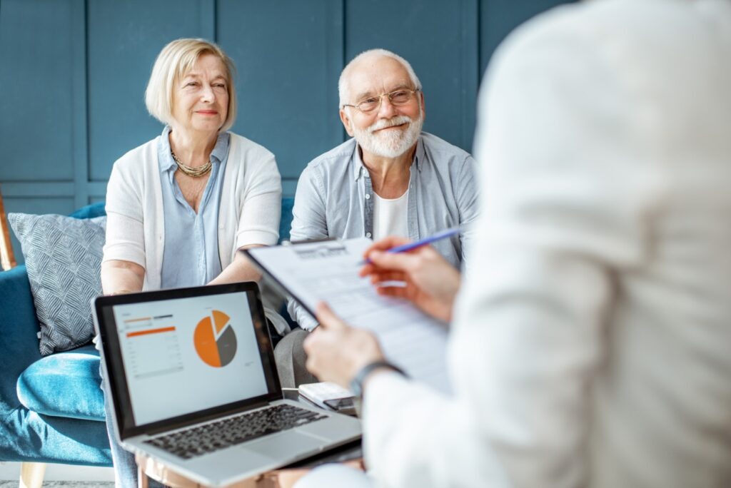 Happy senior couple in the meeting with a consultant about financial planning for retirement home costs