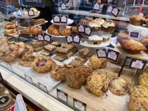 Pastries and baked treats behind a glass display counter at Gabi & Jules Handmade Pies & Baked Goodness