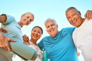 Smiling group of senior friends after an outdoor yoga session