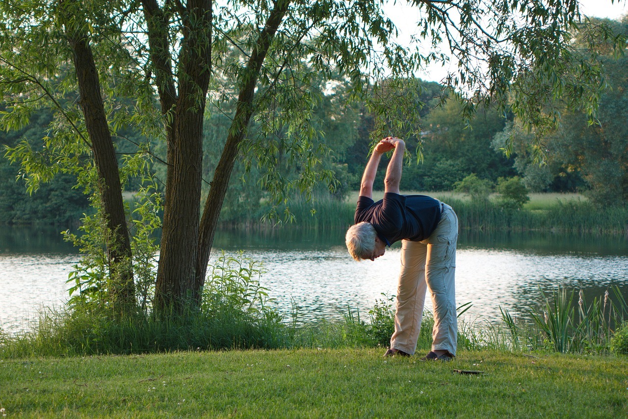Old man doing stretches in the park