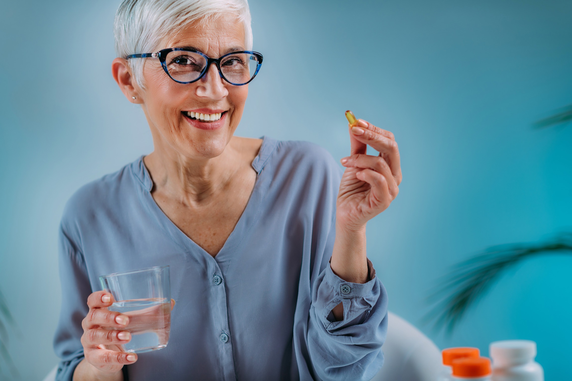 Senior Woman Taking Omega 3 EPA DHA Supplements