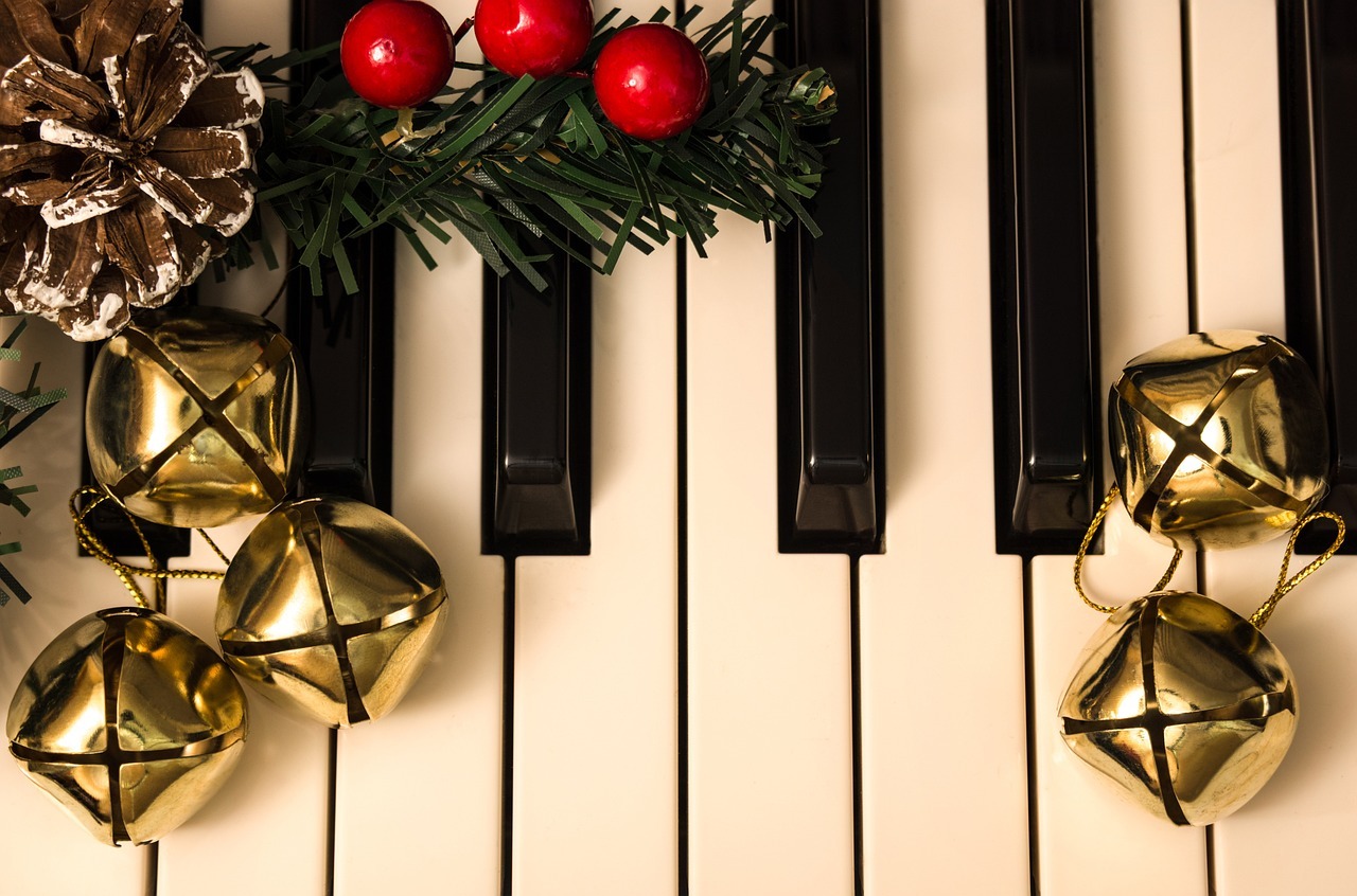 Close up of piano keys decorated with Christmas ornaments