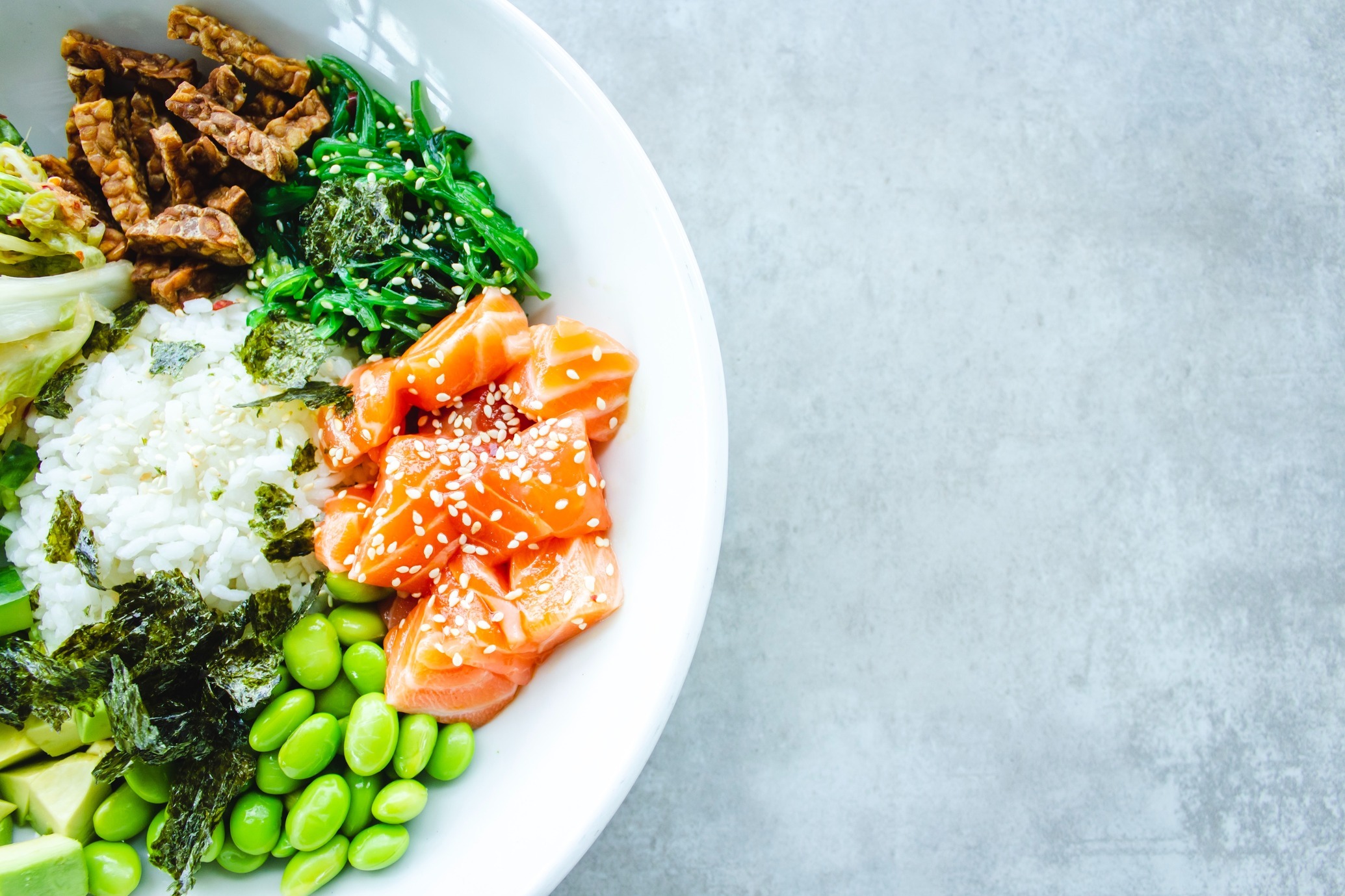 Bowl of greens, whole grains, and salmon