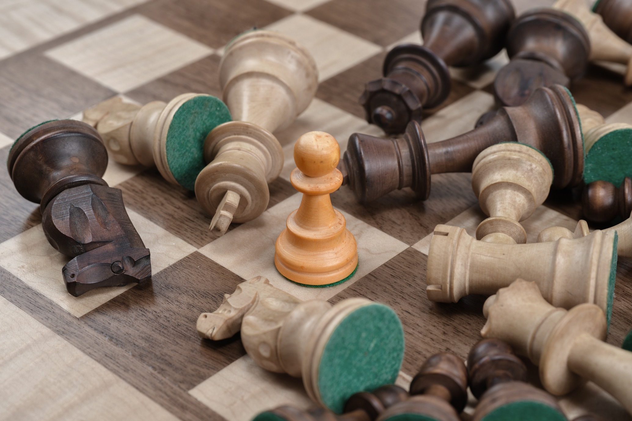 Close up of chess pieces scattered across the board