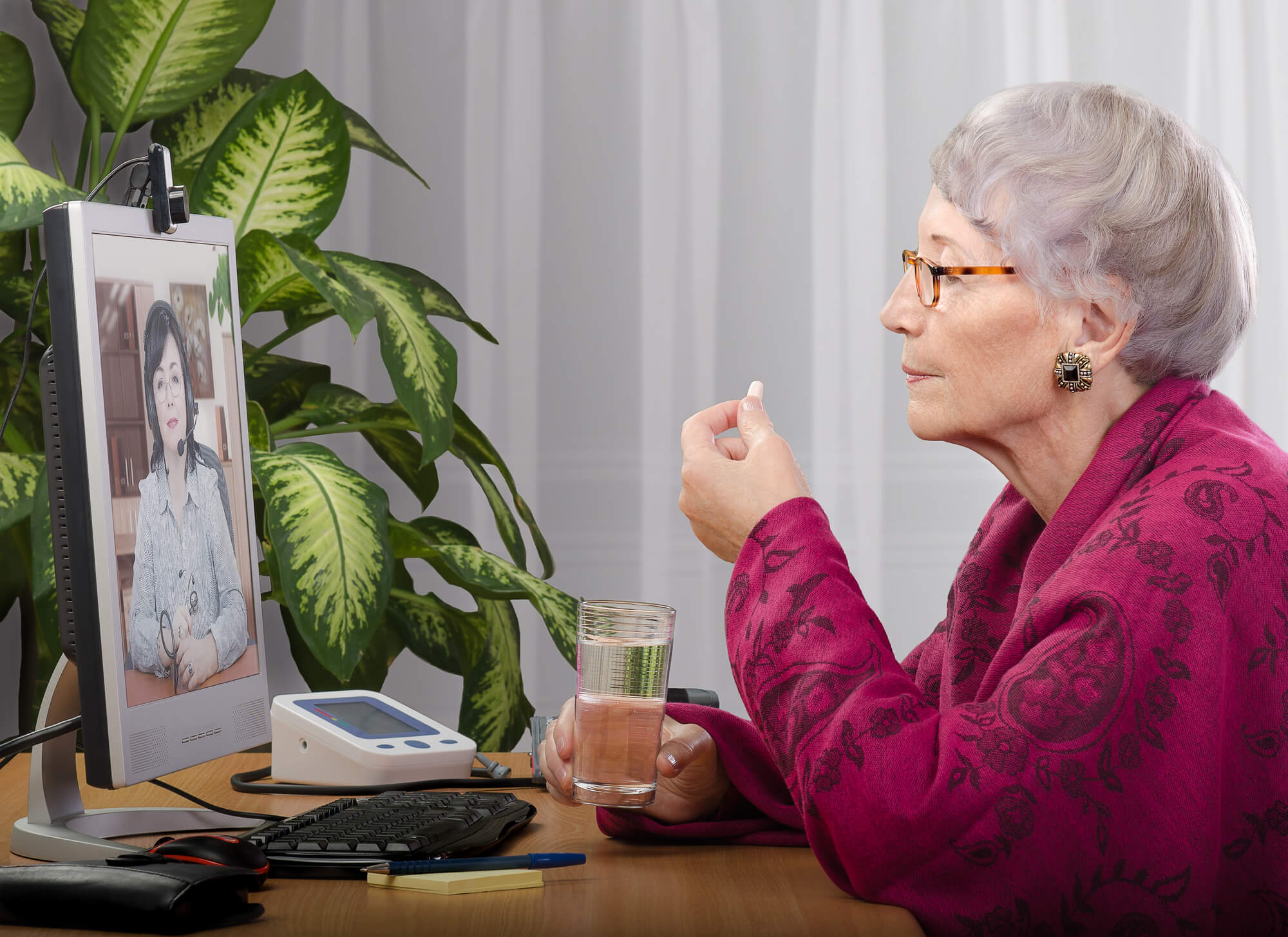 Senior woman in virtual wellness checks video call with doctor