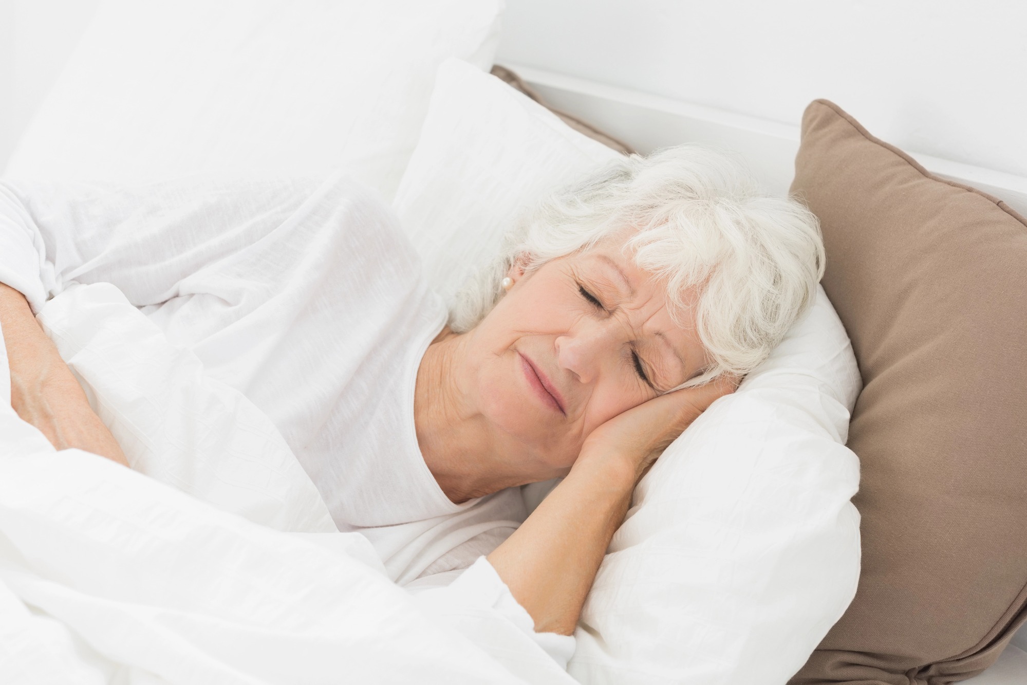 Old woman sleeping in her bed