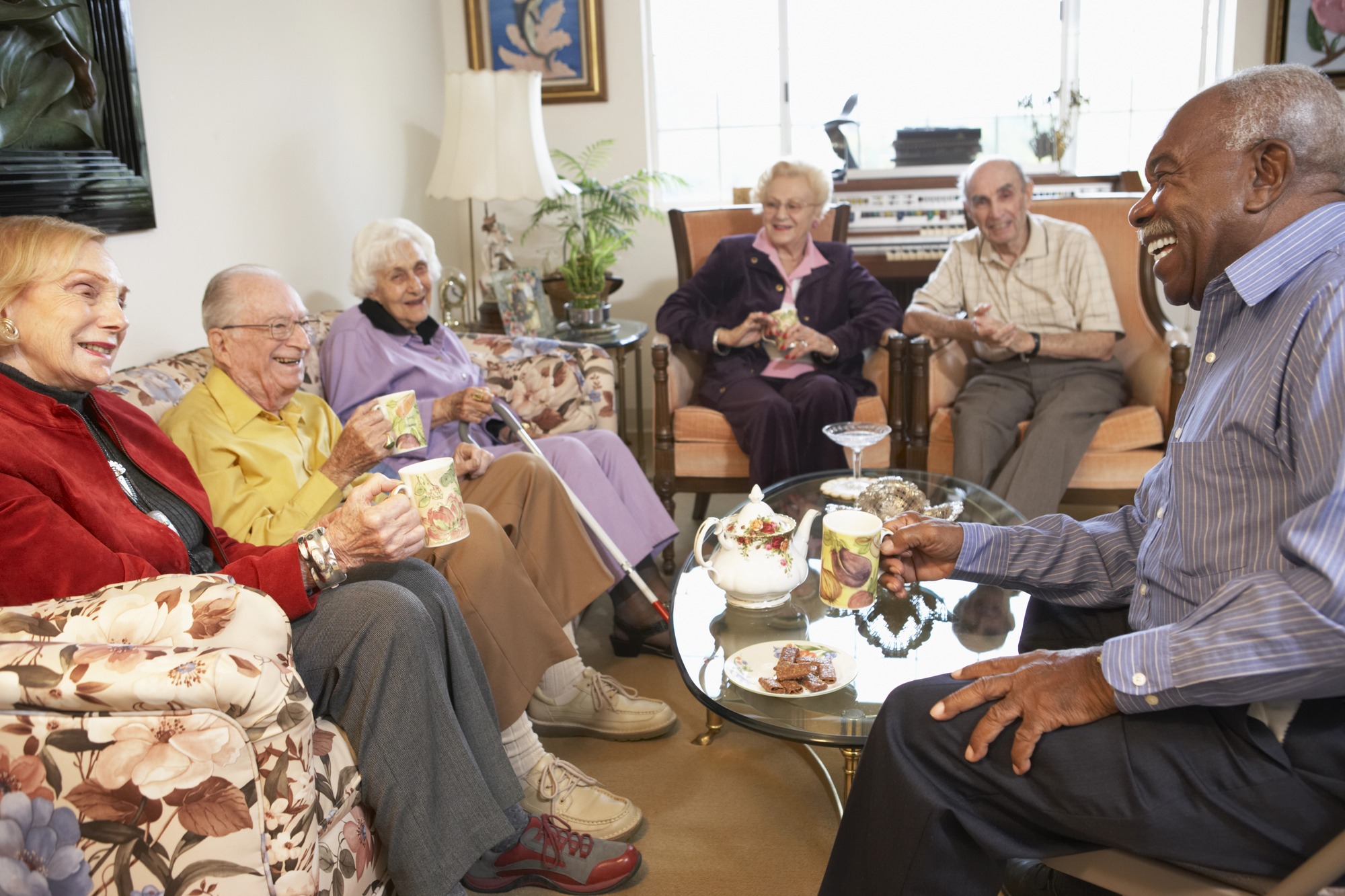 Senior adults having morning tea together