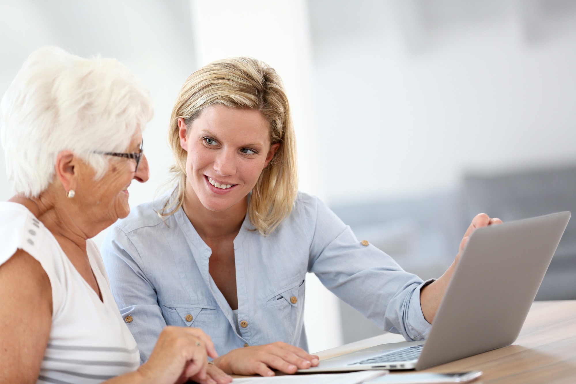 Senior woman receiving technical support with her laptop