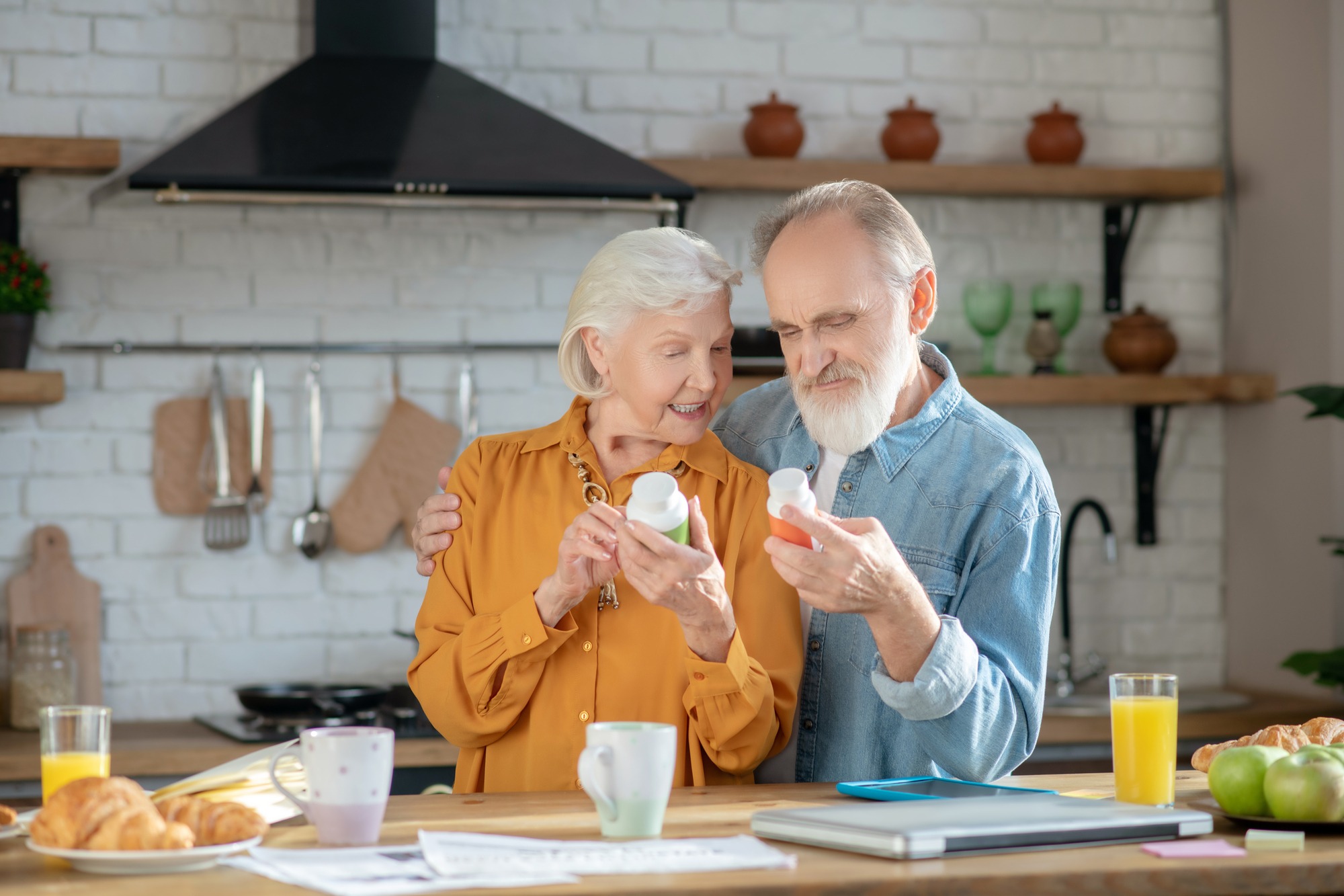 Elderly married couple reading instructions for using supplements