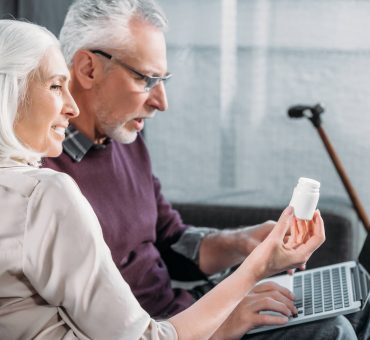 Senior spouses having video call with online doctor and getting a virtual wellness check