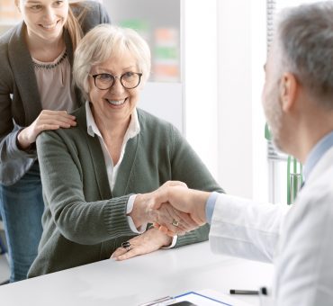 Doctor shaking hands with a senior patient