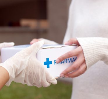 Patient receive medication package box ordered from an online pharmacy